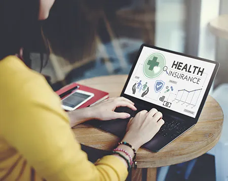 A woman checking about health insurance on the laptop