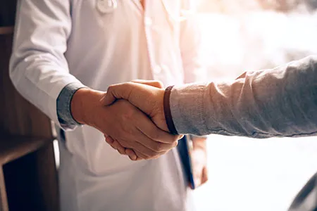 person shaking hands with a doctor